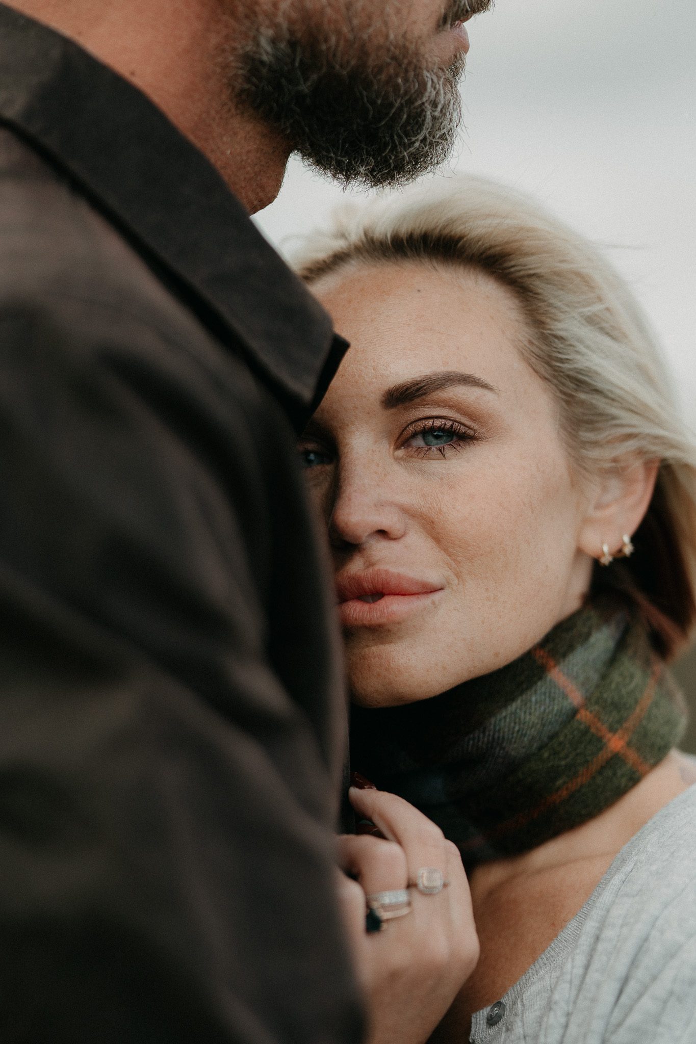 A woman resting her head against a man’s chest